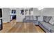 Comfortable living room with a plush gray sectional and hardwood floors at 6434 S Dudley Way, Littleton, CO 80123