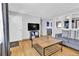 Cozy living room with hardwood floors, gray sofa and adjacent kitchen at 6434 S Dudley Way, Littleton, CO 80123