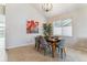 Dining room with a wooden table and gray chairs, complemented by modern artwork at 10470 W Cooper Pl, Littleton, CO 80127