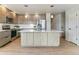 Modern kitchen with a large island, stainless steel appliances, and wood flooring at 10470 W Cooper Pl, Littleton, CO 80127