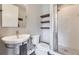 Modern bathroom featuring a white sink, toilet, and glass-enclosed shower at 6849 E Lowry Blvd, Denver, CO 80230