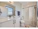 Clean bathroom with white vanity, neutral tile floor, shower-tub combo, and modern fixtures at 6849 E Lowry Blvd, Denver, CO 80230