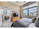 Comfortable bedroom with a view, dresser, and seating area with lots of natural light at 6849 E Lowry Blvd, Denver, CO 80230