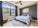 Bedroom with large window, hardwood floors, accent wall, and a ceiling fan at 6849 E Lowry Blvd, Denver, CO 80230