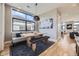 Dining area with bench seating, modern light fixture, and an adjacent living area at 6849 E Lowry Blvd, Denver, CO 80230