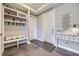 Inviting entryway with built-in bench seating, coat hooks, and decoratively adorned side table at 6849 E Lowry Blvd, Denver, CO 80230