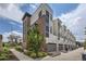 Contemporary townhome complex with stylish brick and siding exterior, plus individual garage doors at 6849 E Lowry Blvd, Denver, CO 80230