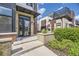 Modern townhome front entrance with brick planter and a black metal awning at 6849 E Lowry Blvd, Denver, CO 80230