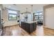 Bright kitchen with an island, modern lighting, stainless steel appliances, and plenty of cabinet space at 6849 E Lowry Blvd, Denver, CO 80230
