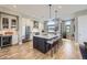 Modern kitchen featuring stainless steel appliances, a center island with seating, and stylish pendant lighting at 6849 E Lowry Blvd, Denver, CO 80230