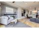 Open concept living room with hardwood floors, fireplace and modern decor at 6849 E Lowry Blvd, Denver, CO 80230