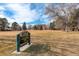 Scenic view of Crestmoor Park with lush grassy field and mature trees under a blue sky at 6849 E Lowry Blvd, Denver, CO 80230
