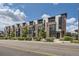 Row of modern townhomes with brick accents, large windows, and street landscaping at 6849 E Lowry Blvd, Denver, CO 80230