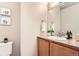 Cozy half bathroom featuring a mirror, vanity, sink, and wall decorations adding a touch of style at 555 Gallegos Cir, Erie, CO 80516