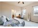 Inviting bedroom featuring a ceiling fan, a mirror, and a comfortable workspace at 555 Gallegos Cir, Erie, CO 80516