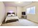Inviting bedroom with a plush bed, stylish headboard and comfortable furnishings and natural light at 555 Gallegos Cir, Erie, CO 80516