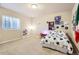 A cozy bedroom with decor, a window for natural light, and carpeted floors at 555 Gallegos Cir, Erie, CO 80516