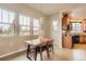 Cozy dining area next to kitchen, featuring a rustic table and modern light fixture at 555 Gallegos Cir, Erie, CO 80516