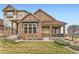 Charming townhome with stone accents, covered porch, and manicured lawn at 555 Gallegos Cir, Erie, CO 80516