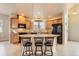 Bright kitchen featuring granite counters, stainless steel appliances, and a center island with bar seating at 555 Gallegos Cir, Erie, CO 80516