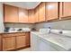Functional laundry room equipped with a sink, ample cabinetry, and modern washer and dryer units at 555 Gallegos Cir, Erie, CO 80516