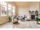Spacious living room featuring large windows, fireplace, and comfortable seating at 555 Gallegos Cir, Erie, CO 80516