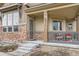 Inviting front porch with stylish railings, stone accents, and a cozy seating area at 555 Gallegos Cir, Erie, CO 80516