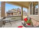 Charming porch area with seating, table and view of well-kept lawns and neighboring homes at 555 Gallegos Cir, Erie, CO 80516