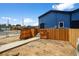 New blue townhome featuring a private fenced back yard with freshly laid walkway at 1335 N Alton St, Aurora, CO 80010