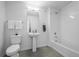 Modern bathroom featuring white subway tile, pedestal sink, and shower over tub at 1335 N Alton St, Aurora, CO 80010