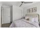 Bright bedroom featuring a brass bed frame, ceiling fan and closet with sliding doors at 1335 N Alton St, Aurora, CO 80010