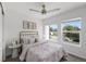 Serene bedroom with a brass bed frame, soft bedding, and natural light from two windows at 1335 N Alton St, Aurora, CO 80010
