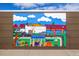 Colorful community mural on the side of a building depicting neighborhood scenes and community life at 1335 N Alton St, Aurora, CO 80010