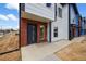 New townhome featuring a brick facade, gray trim, and inviting covered front entrance at 1335 N Alton St, Aurora, CO 80010