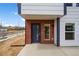 Modern townhome with red brick and blue door, complemented by a clean, newly poured concrete porch at 1335 N Alton St, Aurora, CO 80010