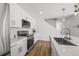 Bright, modern kitchen with white cabinets, stainless steel appliances, and quartz countertops at 1335 N Alton St, Aurora, CO 80010