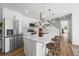 Modern kitchen with stainless steel appliances, quartz countertops, and large island with seating at 1335 N Alton St, Aurora, CO 80010