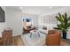 Cozy living room featuring stylish seating, wood floors, and bright, neutral decor at 1335 N Alton St, Aurora, CO 80010
