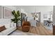 Open-concept living space with stylish furniture and seamless flow to the kitchen and dining areas at 1335 N Alton St, Aurora, CO 80010
