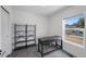 Bright office space with gray carpet and desk, shelving unit, and a view of the street at 1335 N Alton St, Aurora, CO 80010