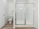 Modern bathroom featuring tiled shower with glass doors, toilet, and tile floors at 2887 E 103Rd Dr, Thornton, CO 80229