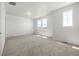Spacious carpeted bedroom with multiple windows, offering ample natural light at 2887 E 103Rd Dr, Thornton, CO 80229