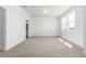Well-lit bedroom with neutral carpet, three windows, and a bathroom entrance at 2887 E 103Rd Dr, Thornton, CO 80229