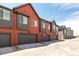 Eye-level exterior of a townhouse featuring private garages at 2887 E 103Rd Dr, Thornton, CO 80229