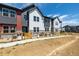Colorful townhome exteriors featuring unique designs, stone accents, and fenced front yards at 2887 E 103Rd Dr, Thornton, CO 80229
