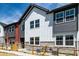 Modern townhome exterior showcasing a blend of white siding, grey accents, and large windows at 2887 E 103Rd Dr, Thornton, CO 80229