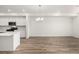 Open-concept kitchen with stainless steel appliances and white cabinetry at 2887 E 103Rd Dr, Thornton, CO 80229