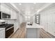 Bright kitchen with a large island, stainless steel appliances, and modern finishes at 2887 E 103Rd Dr, Thornton, CO 80229