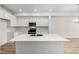 Contemporary kitchen with sleek white cabinets, stainless appliances, and island at 2887 E 103Rd Dr, Thornton, CO 80229