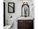 Well-lit bathroom with vanity, framed mirror, and toilet at 550 S Xenon Ct, Lakewood, CO 80228